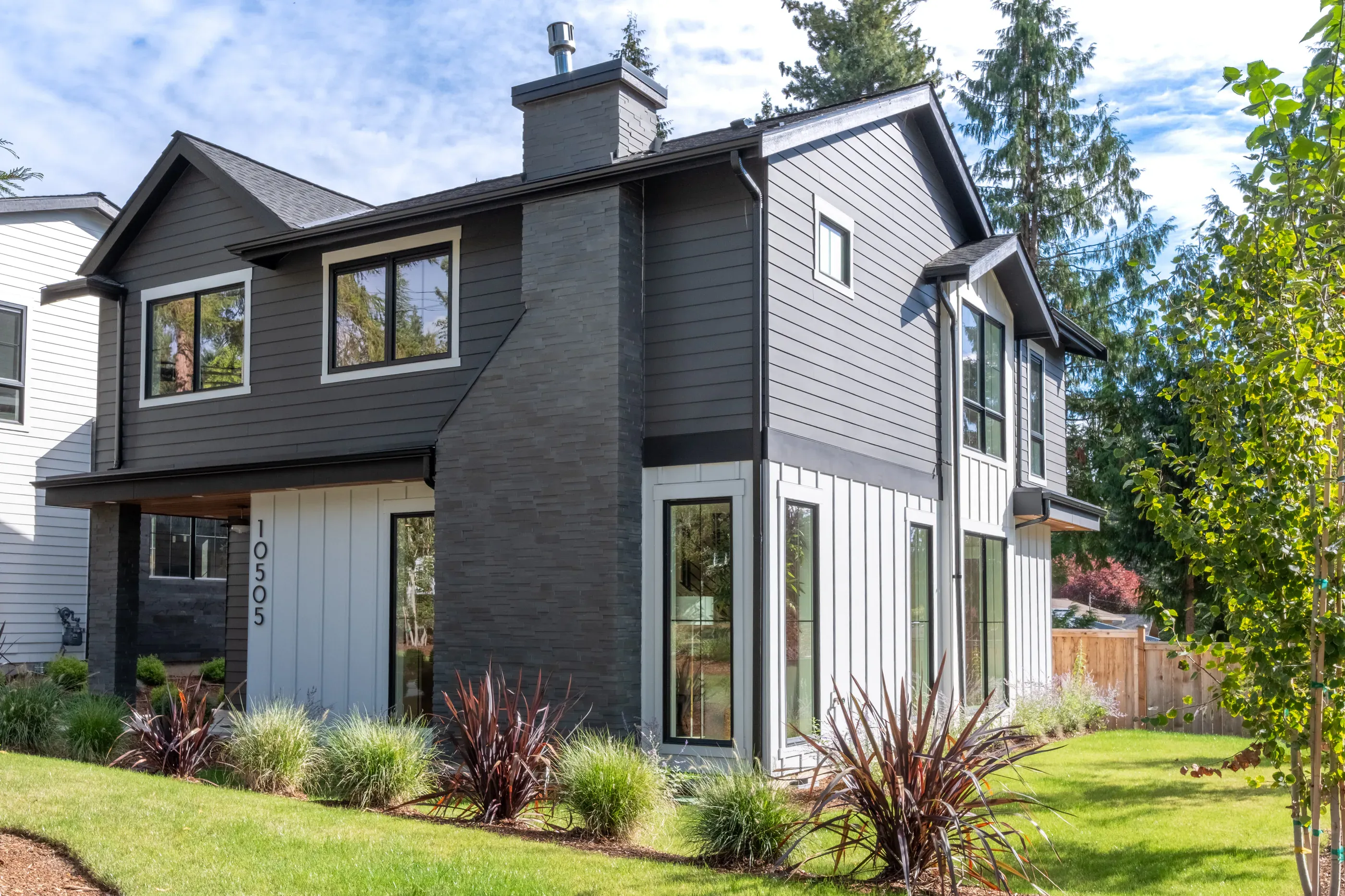 Modern two-story home exterior with landscaped front yard.