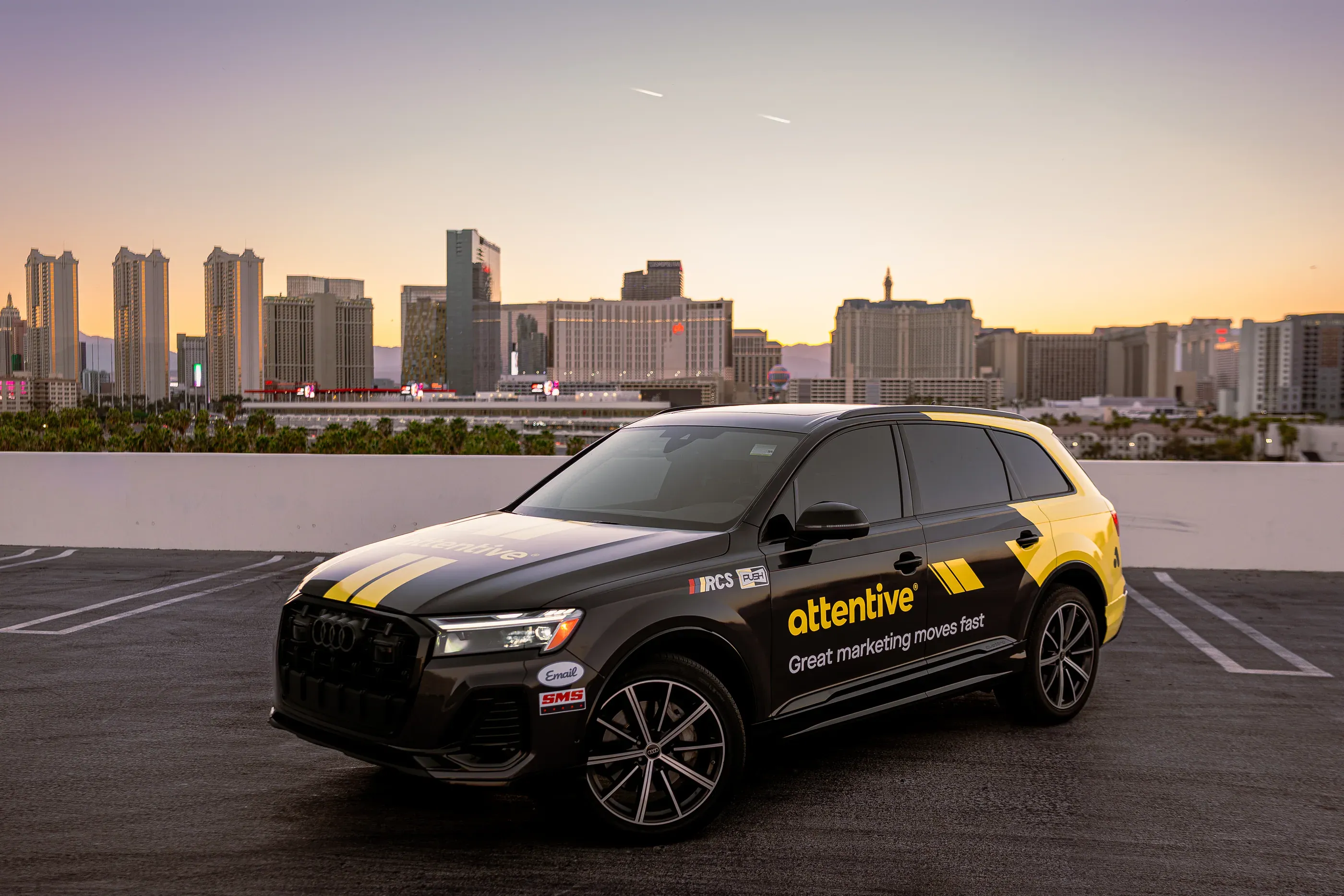 Attentive-branded SUV parked on a rooftop at sunset.
