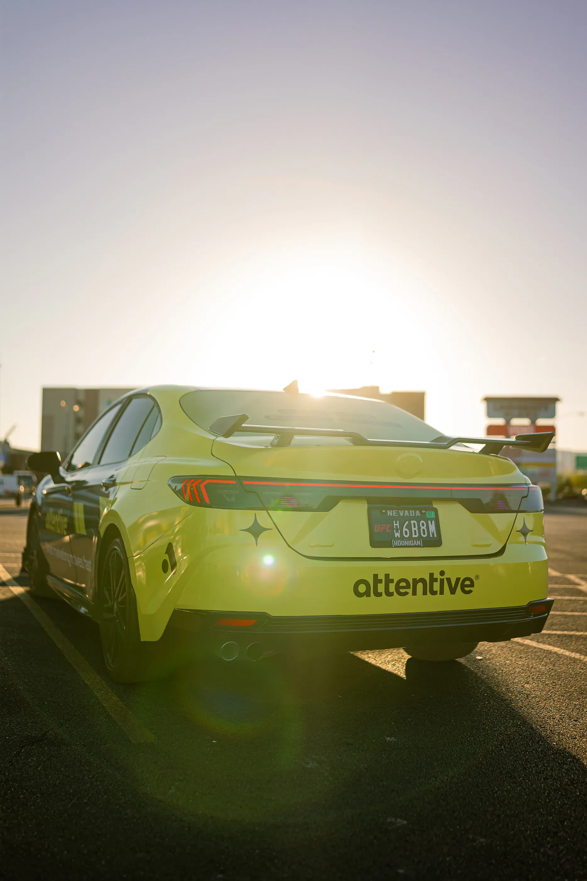 Attentive-branded car photographed through bright evening sun.