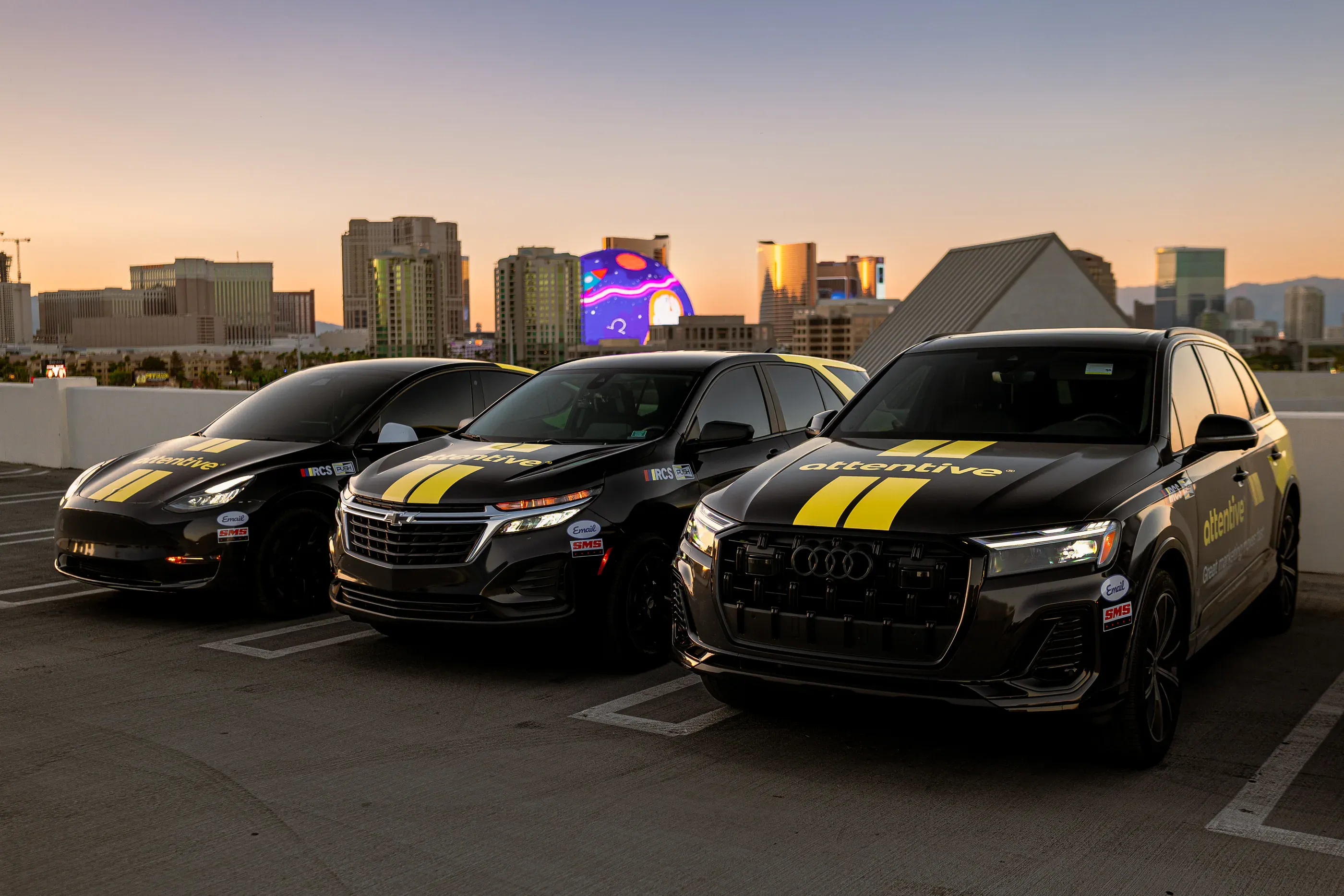Line of Attentive-branded vehicles parked on a rooftop.