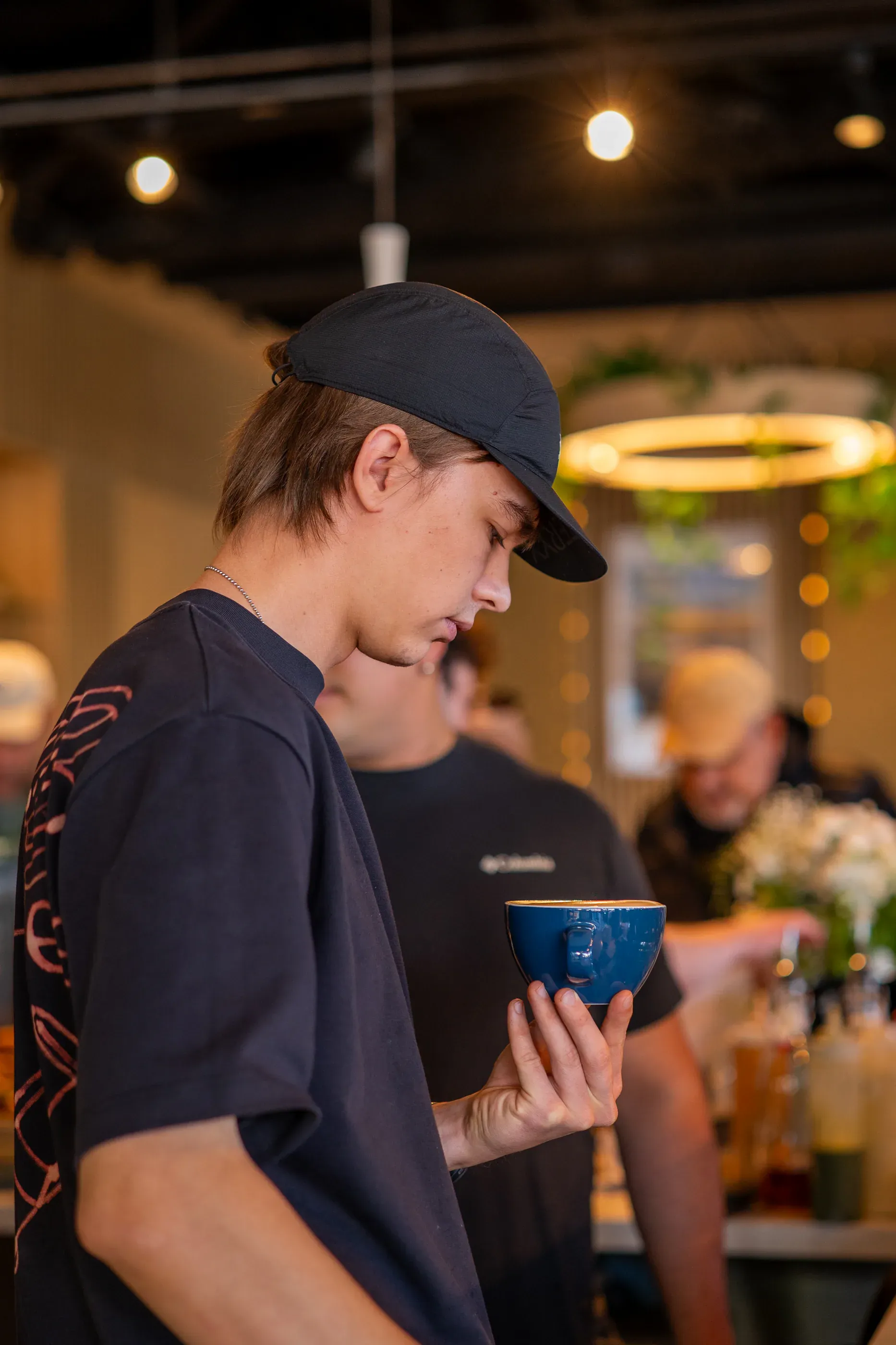 Cafe employee carries items through the dining area.