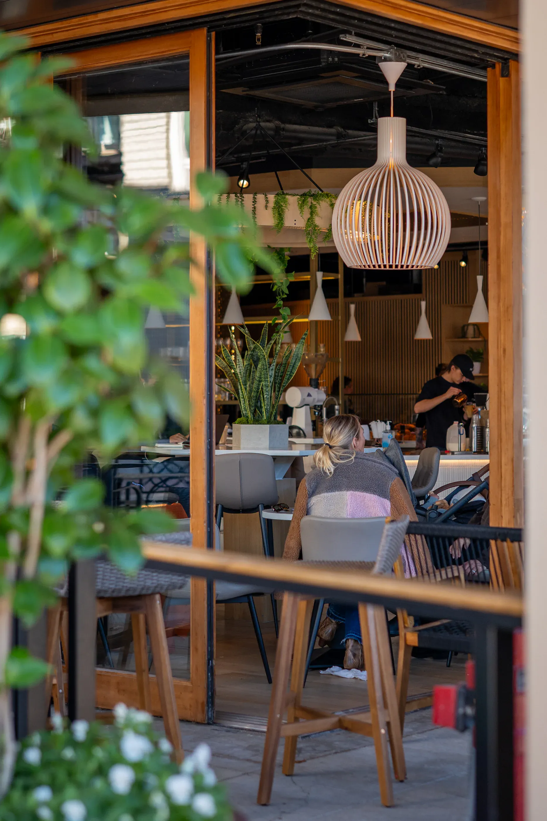 Covered patio seating outside a cafe entrance.