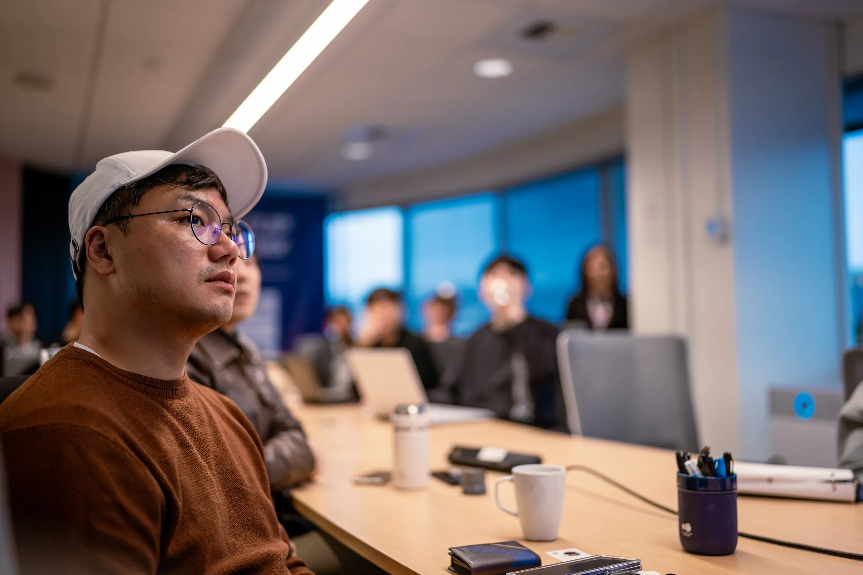 Participant listens during a meeting in a conference room.