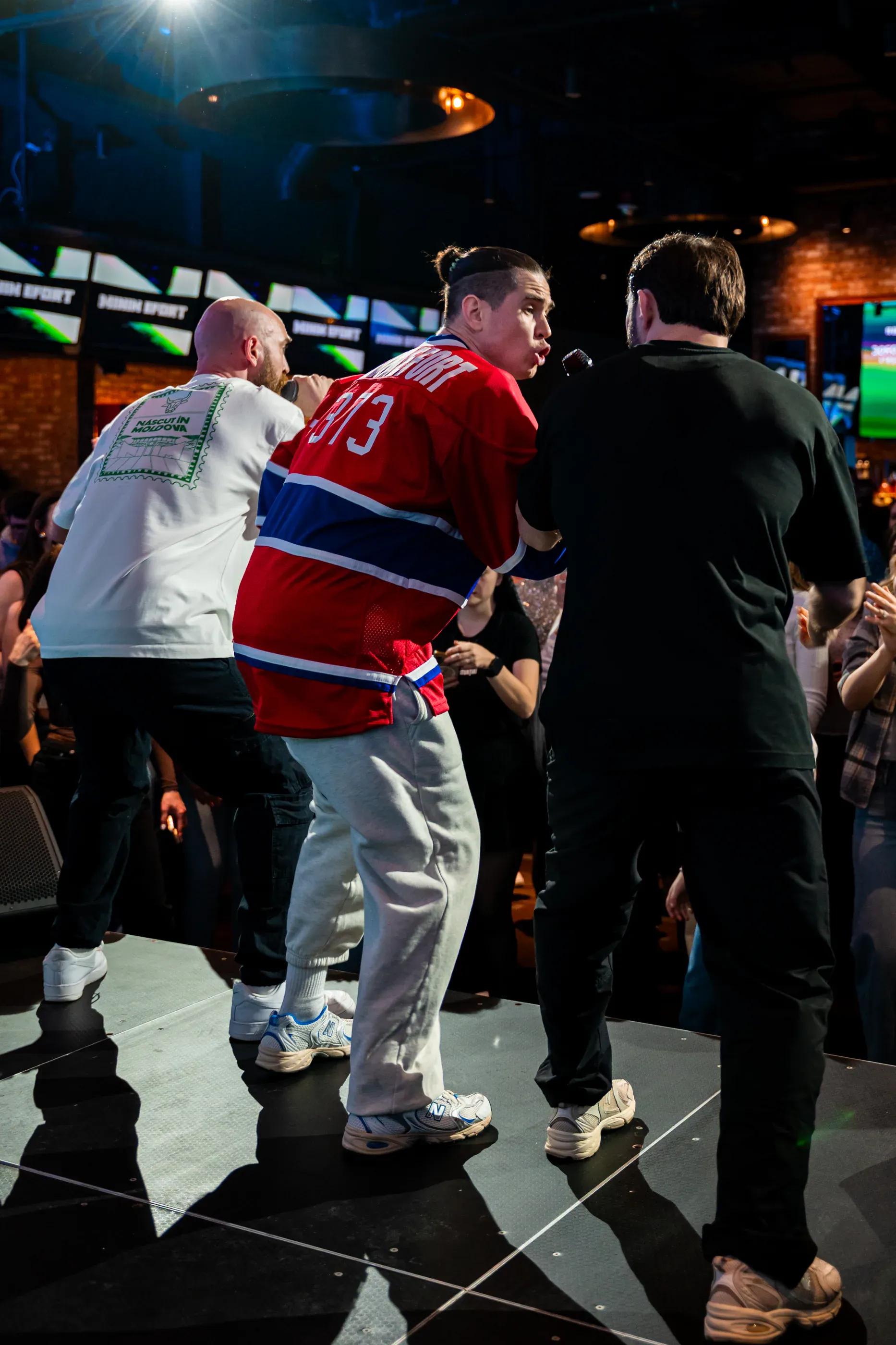 Two performers move through the crowd during a concert.