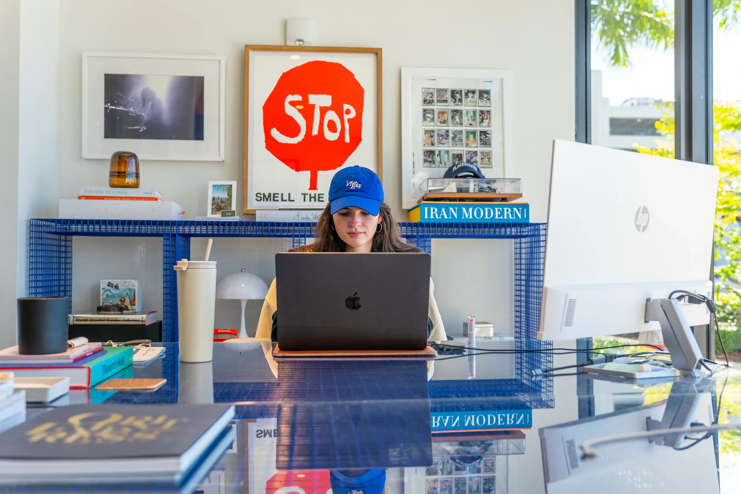 Person works at a laptop in a colorful office setting.