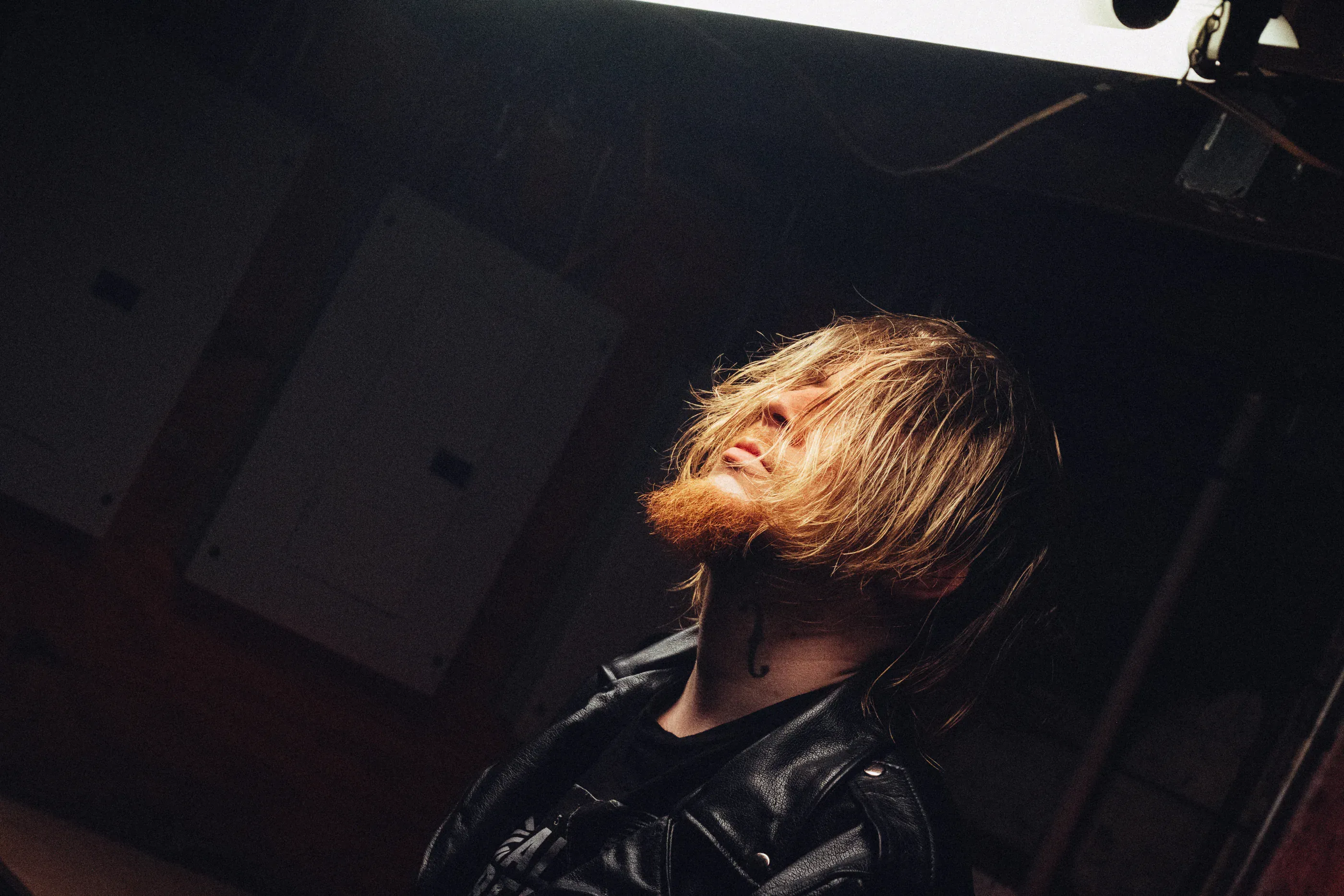 Portrait of Dmitry Nuberg in dramatic warm side light.